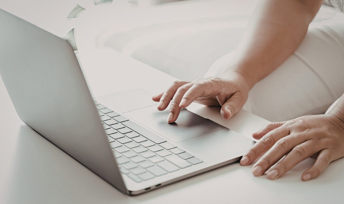 Landlord reviewing tenancy details and rental advert on laptop