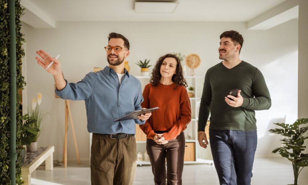 Estate agent showing a modern apartment to a couple during a property viewing in Chelmsford city centre
