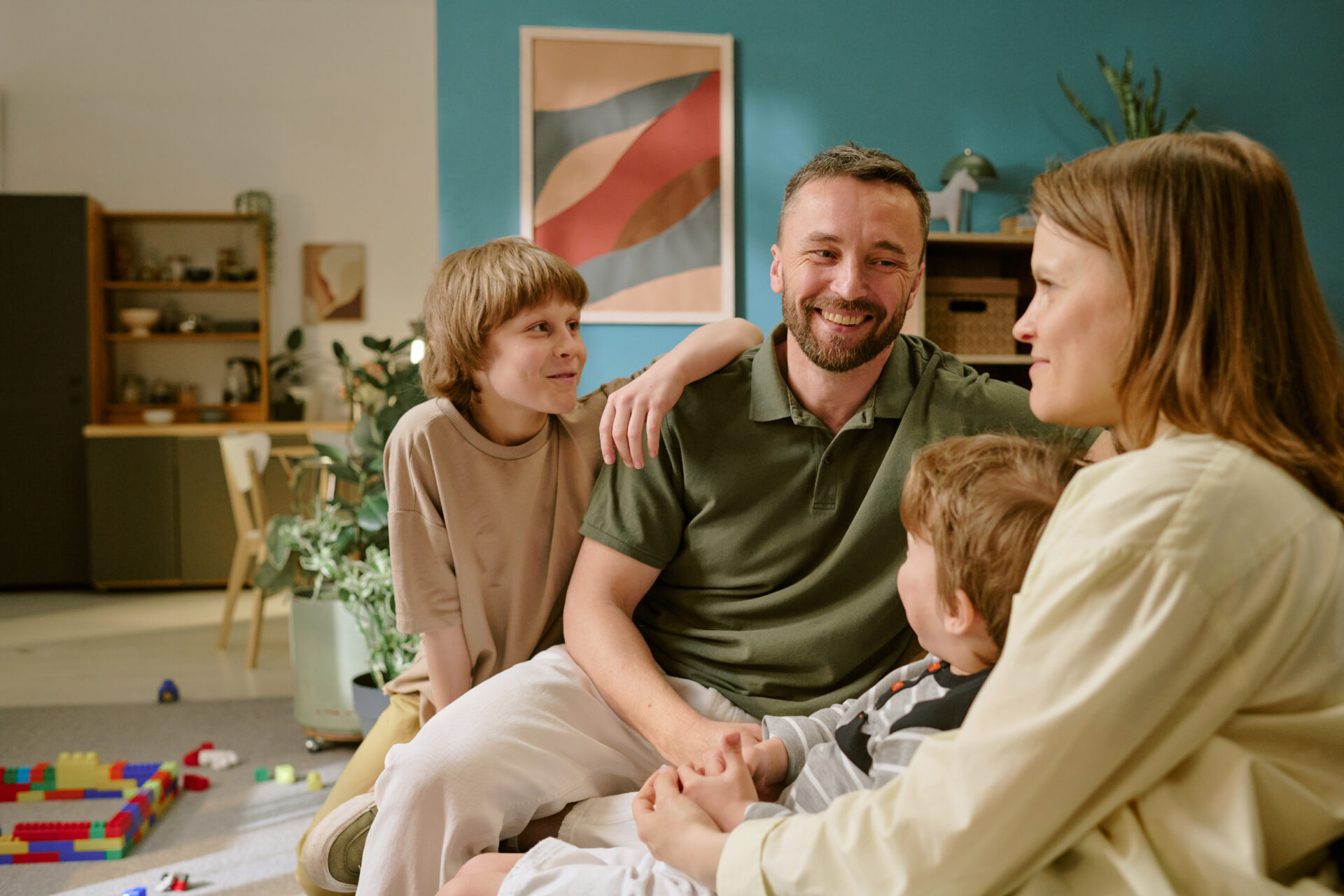 Family sitting together in a modern living room in a spacious Tadley home, representing family-friendly living on Franklin Avenue