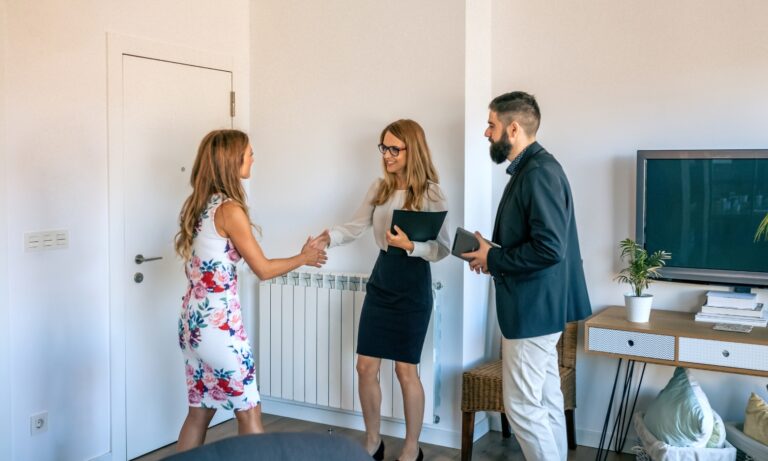 Letting agent discussing a buy-to-let property with landlords in a modern Bury St Edmunds home