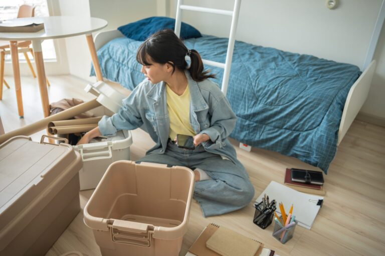 Student tenant organising belongings in a modern Coventry HMO rental property covered by 2026 licensing rules