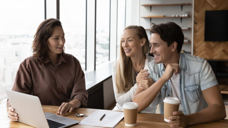 Letting agent advising a couple at a desk, representing Tunbridge Wells rental yields and buy-to-let investment guidance.