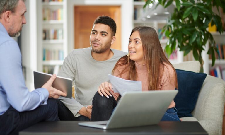 Property adviser discussing buying and renting options with a couple in Guiseley LS20, a popular Leeds commuter location.