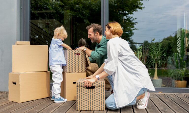 Family unpacking boxes in their new home in Pangbourne RG8, reflecting the village's appeal for buyers, renters and families seeking a premium lifestyle.