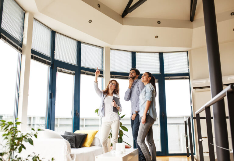 Letting agent showing tenants around a bright rental property, representing Wigan selective licensing and landlord compliance in 2026.