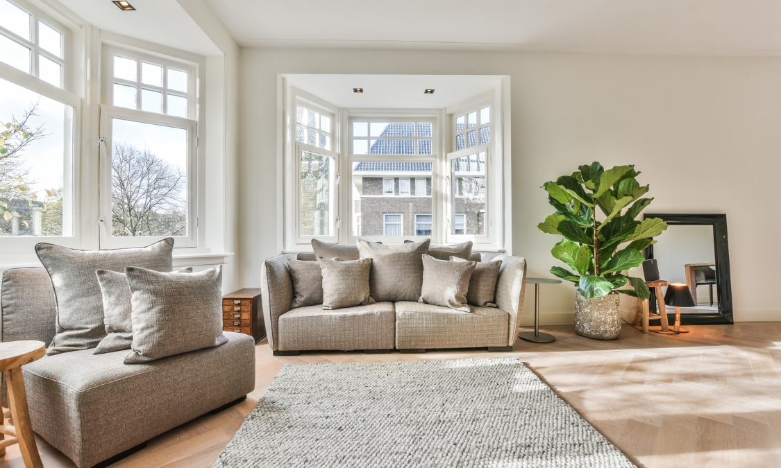 Modern, well-presented living room with large windows, neutral décor and comfortable furnishings, illustrating a property prepared for sale in the Cannock property market in 2026.