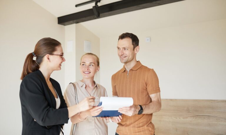 A letting agent discussing tenancy documents with landlords during a property consultation in Stone.