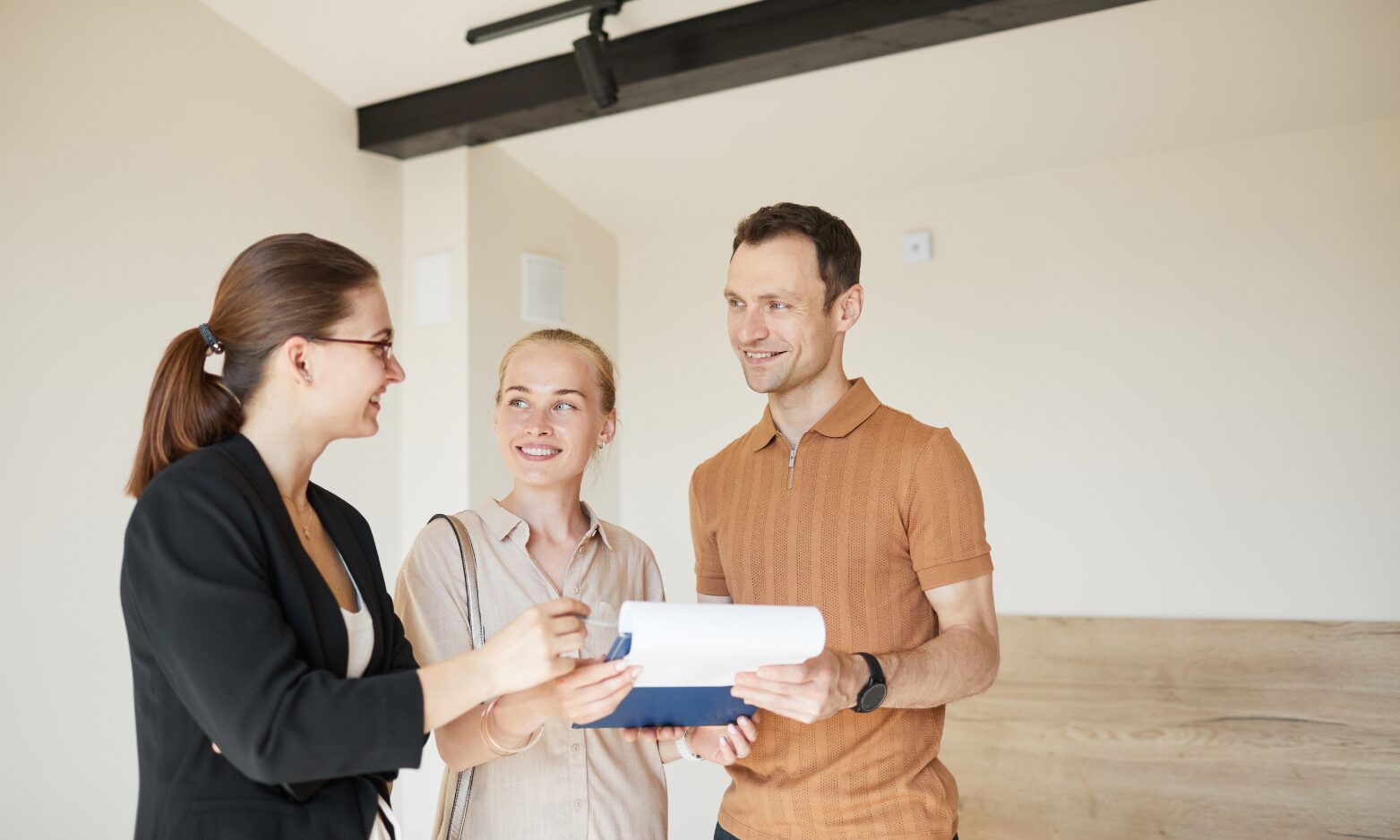 A letting agent discussing tenancy documents with landlords during a property consultation in Stone.