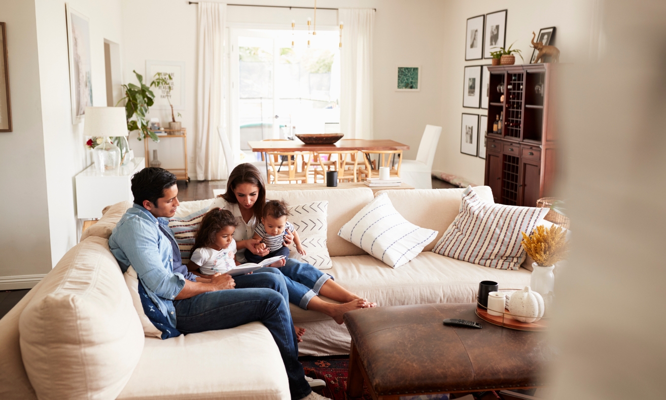 A family relaxing together in a bright, modern living room, representing a comfortable and energy-efficient rental property that reflects the EPC upgrade improvements discussed for Tunbridge Wells landlords.