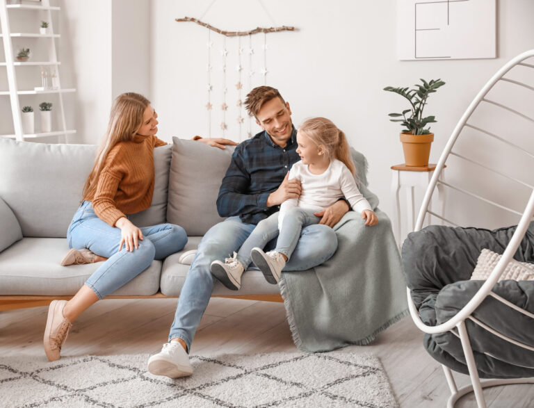 Family relaxing together in their home, representing homeowners considering upsizing to a larger property in Wigan.