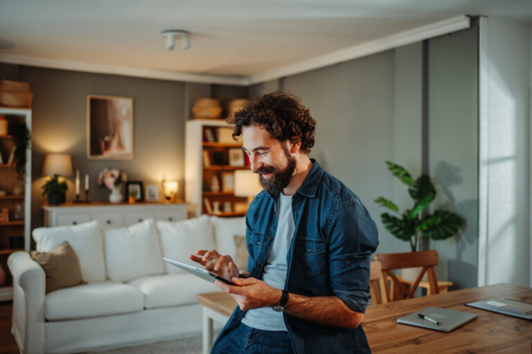 Man using a tablet in a modern living room in Wilnecote